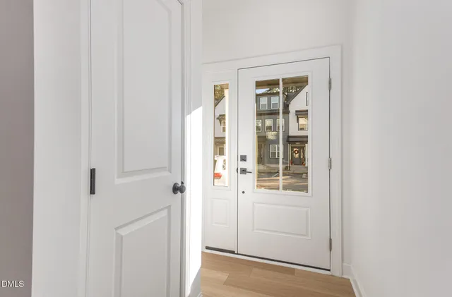 a front view of a residential apartment building with a yard