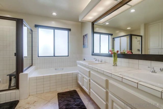 a view of a house with a wooden fence