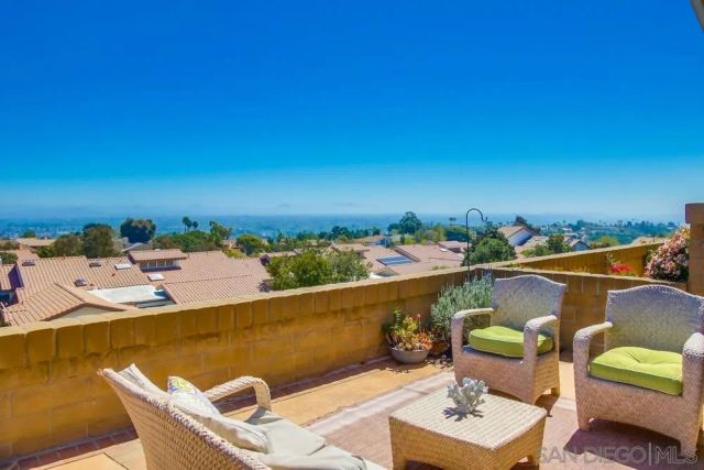 a view of a swimming pool with a patio and plants