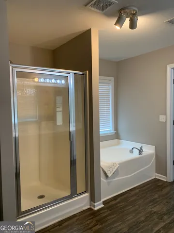 a bathroom with a bathtub and a shower