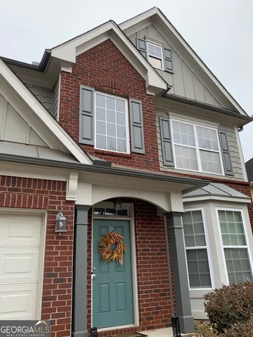 a front view of a house with a yard