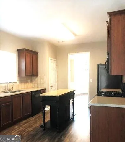a kitchen with a sink and a refrigerator
