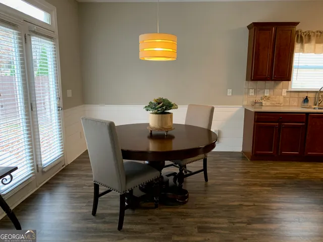 a view of a dining room with furniture and wooden floor