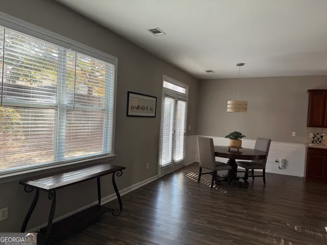 a view of a dining room with furniture and wooden floor
