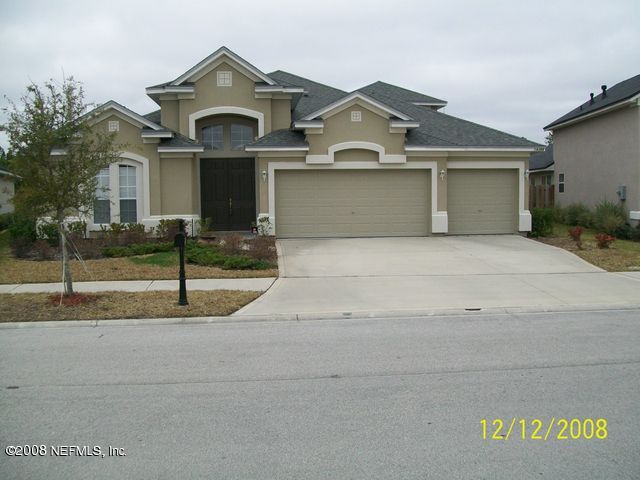 14366 Millhopper Road Jacksonville, FL 32258 - Photo 1 of 1 a front view of a house with a yard