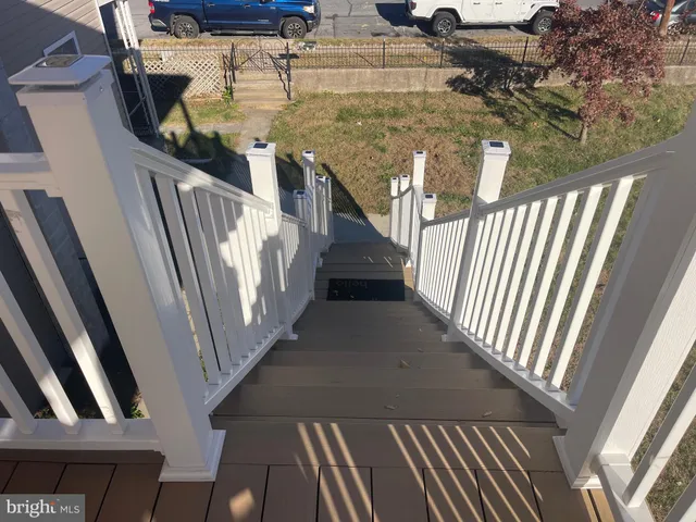 a kitchen with granite countertop white cabinets sink and window