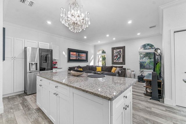 a kitchen with center island and stainless steel appliances