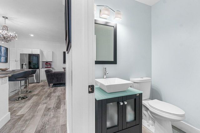 a bathroom with a toilet a sink and a mirror