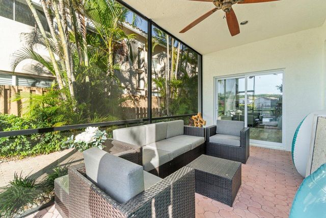 a balcony with furniture and a potted plant