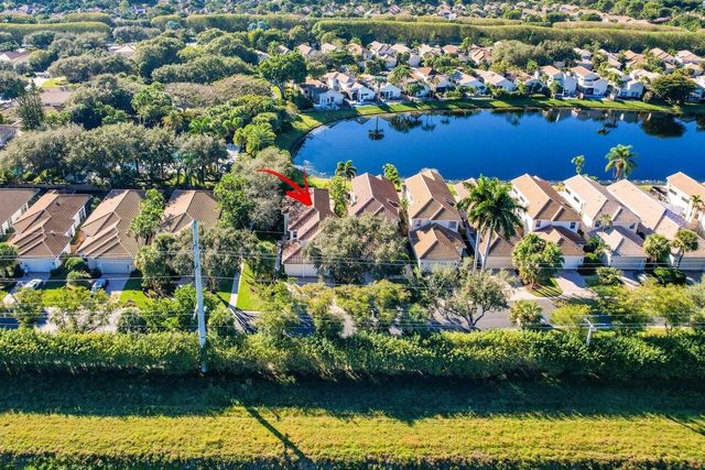 an aerial view of a houses with a lake view