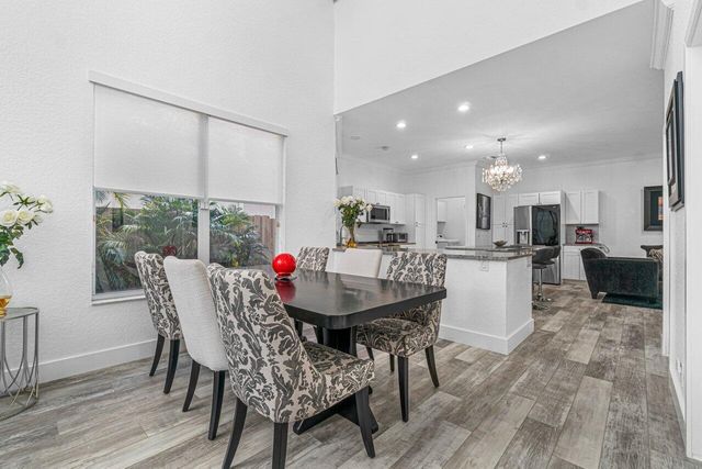 a dining room with furniture and wooden floor