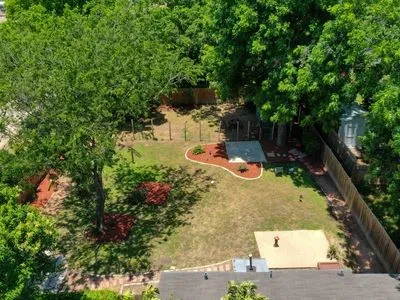 an aerial view of a house with a yard
