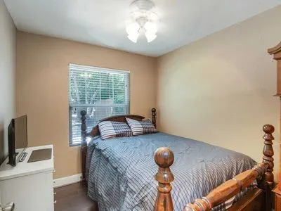 a bedroom with furniture and a window