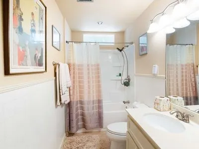 a bathroom with a sink toilet tub and shower