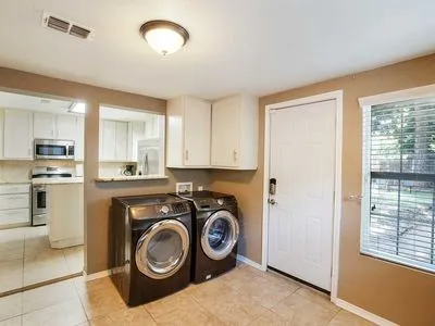a view of a kitchen with washer and dryer