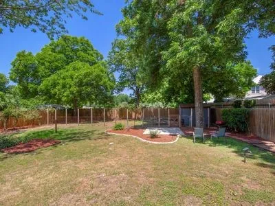 a backyard of a house with barbeque oven