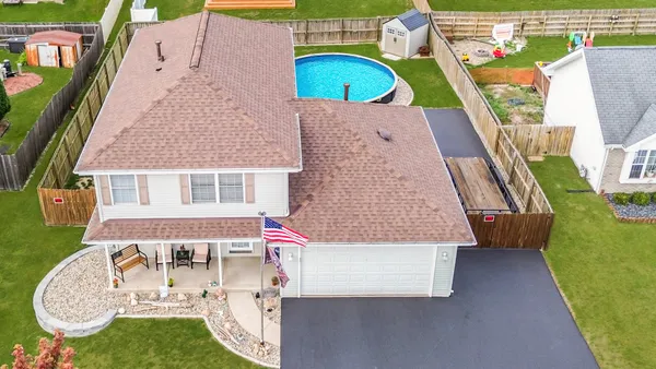 an aerial view of a house with outdoor space patio and swimming pool