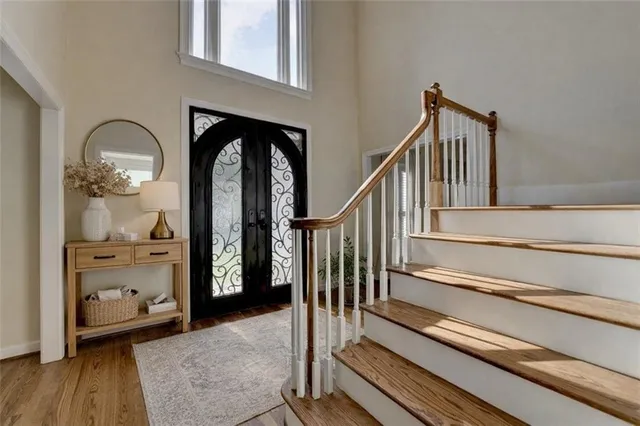a living room with couches and white couches with wooden floor