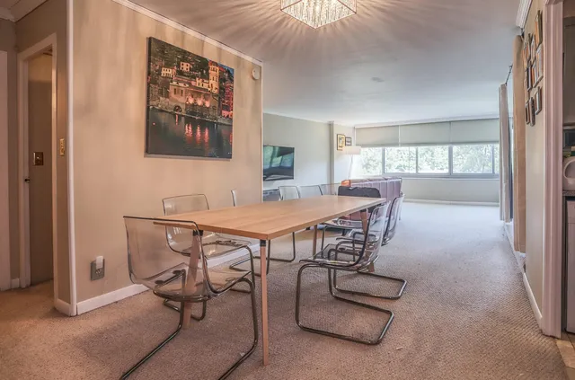 a view of a dining room with furniture and a window
