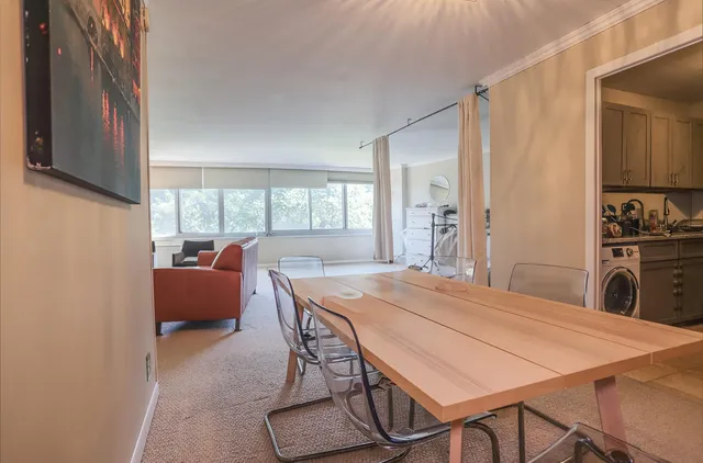 a dining room with furniture and window