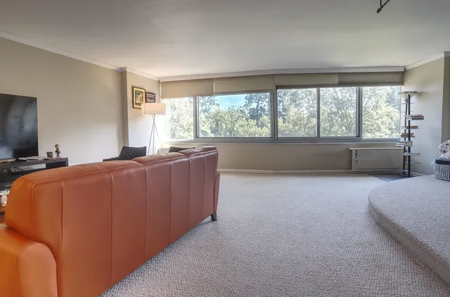 a bed room with a bed and a large window