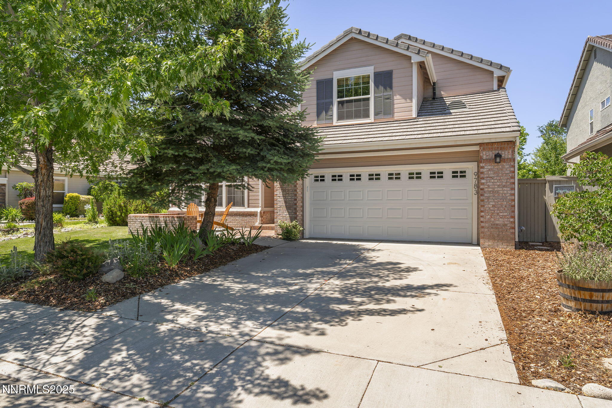 9783 Northrup Drive Reno, NV 89521 - Photo 1 of 39 a front view of a house with a yard and garage