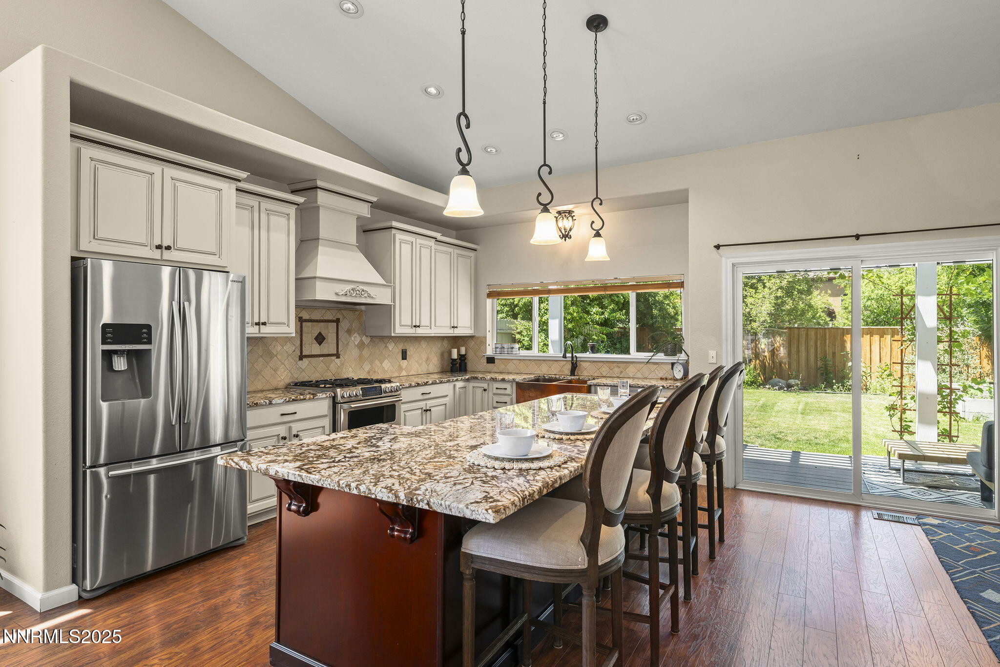 9783 Northrup Drive Reno, NV 89521 - Photo 11 of 39 a kitchen with stainless steel appliances granite countertop a stove a refrigerator a kitchen island a table and chairs