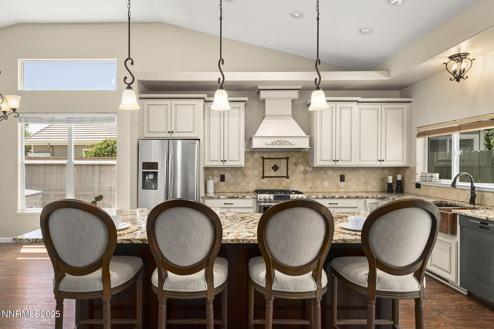 9783 Northrup Drive Reno, NV 89521 - Photo 13 of 39 a kitchen with stainless steel appliances a table chairs and chandelier