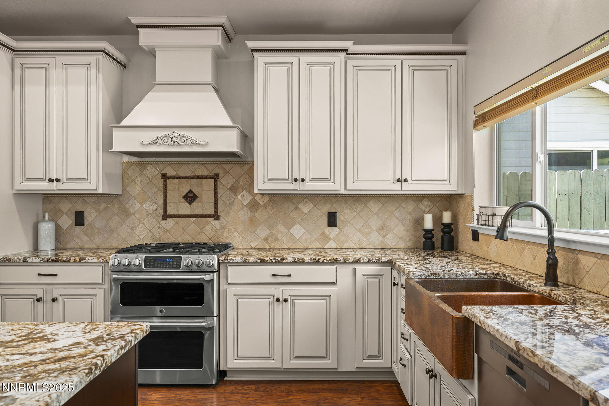 9783 Northrup Drive Reno, NV 89521 - Photo 14 of 39 a kitchen with granite countertop a stove sink and cabinets