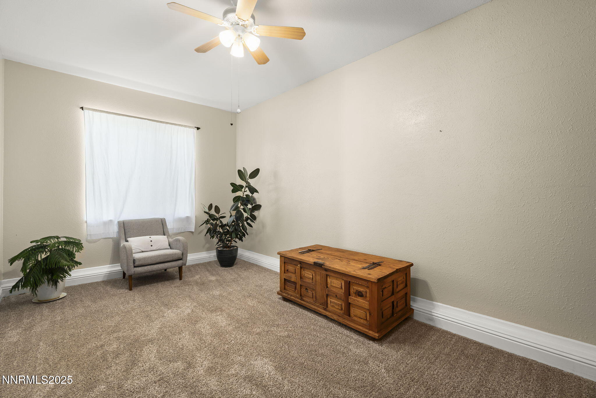 9783 Northrup Drive Reno, NV 89521 - Photo 17 of 39 a living room with furniture and a chandelier