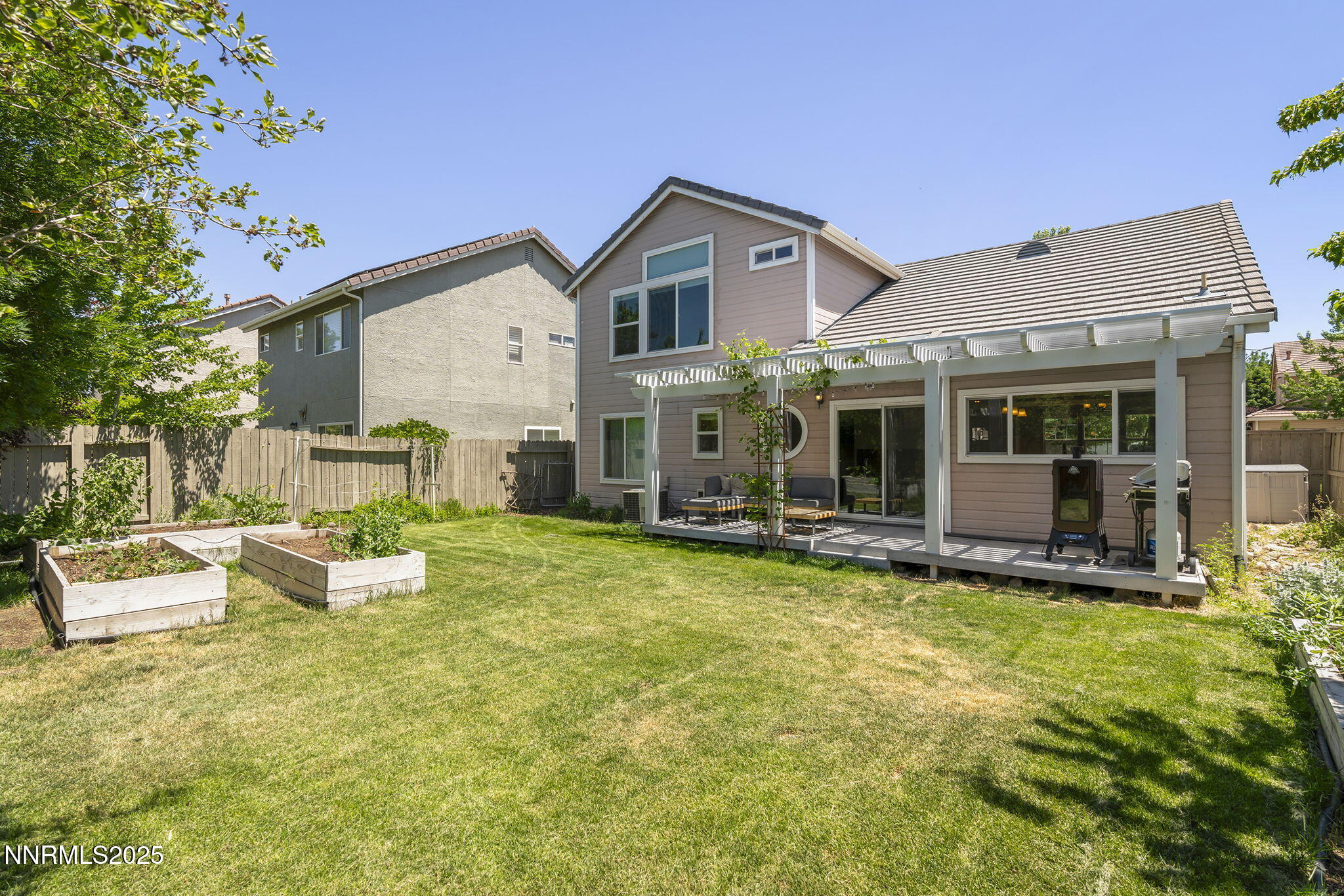 9783 Northrup Drive Reno, NV 89521 - Photo 29 of 39 a view of a house with backyard sitting area and garden