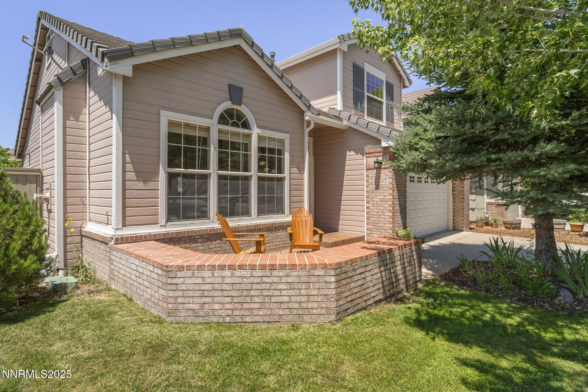 9783 Northrup Drive Reno, NV 89521 - Photo 4 of 39 a front view of house with yard and trees in the background