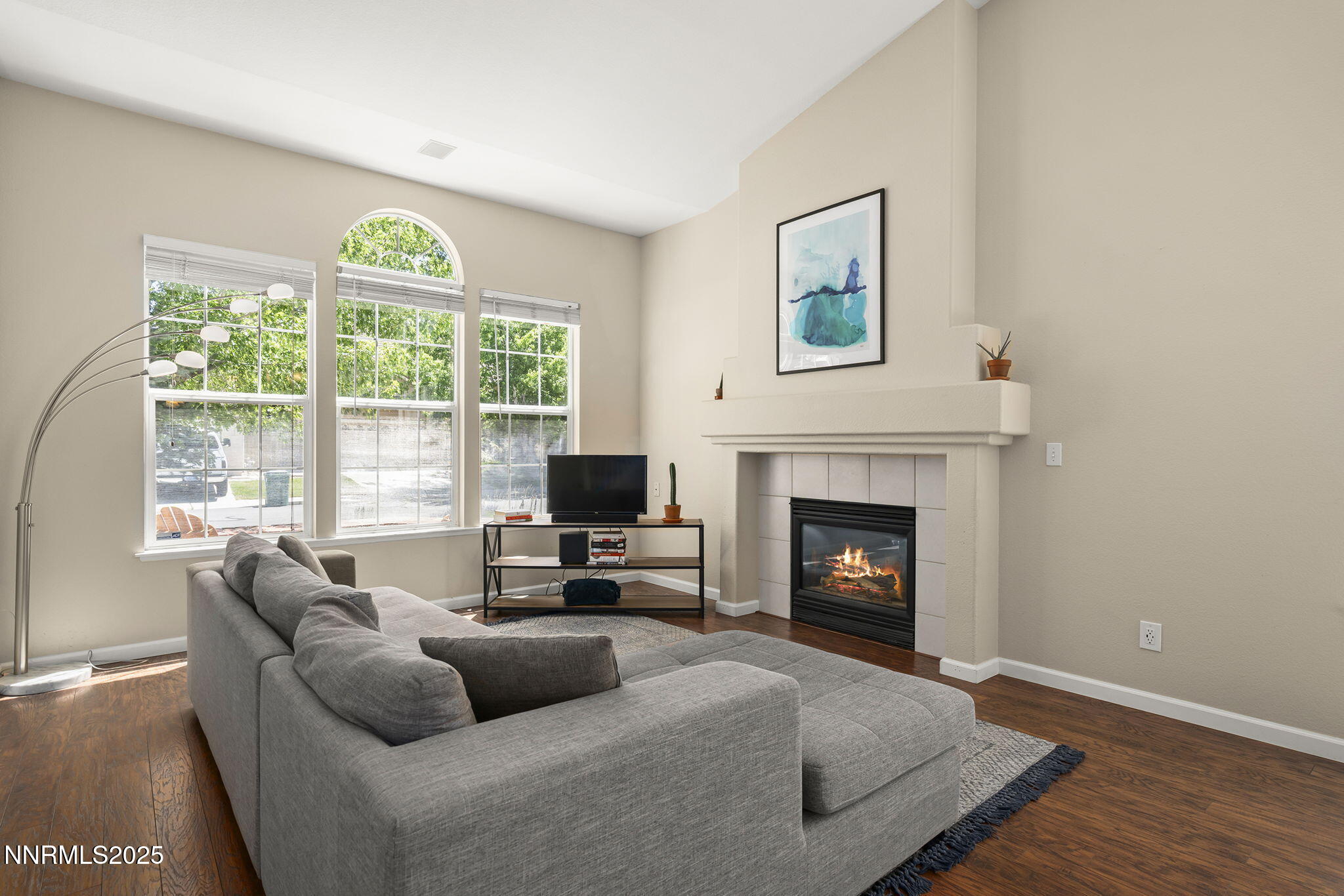 9783 Northrup Drive Reno, NV 89521 - Photo 7 of 39 a living room with furniture a fireplace and a floor to ceiling window