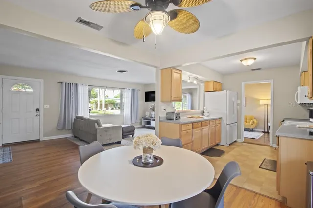 a dining room with furniture a window and wooden floor