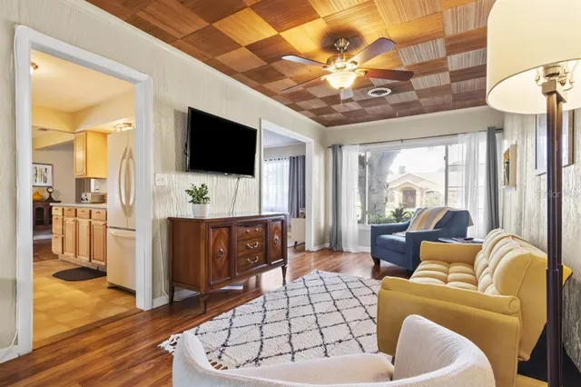 a living room with furniture a large window and a flat screen tv