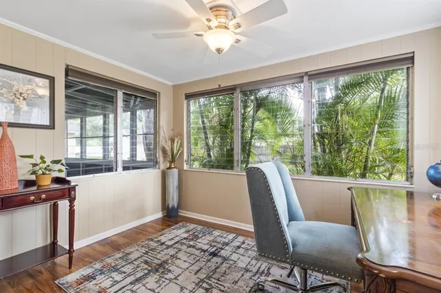 a view of a workspace with furniture and a window