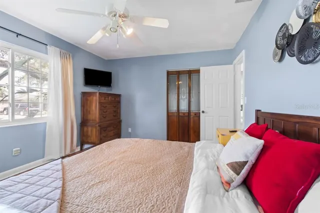 a bedroom with a large bed and a window