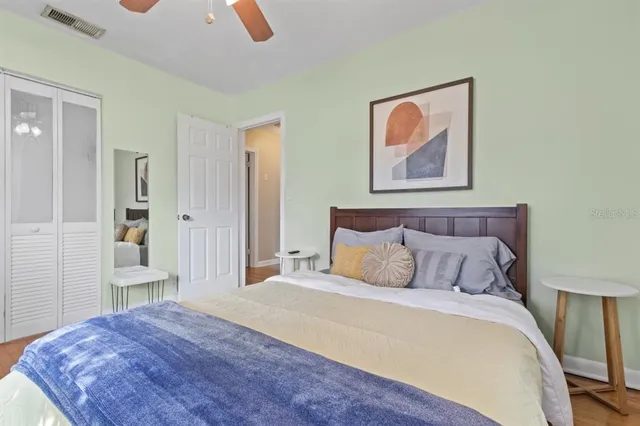 a bedroom with a bed and a painting on the wall