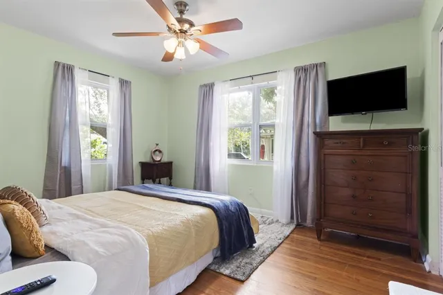 a bedroom with a bed and a flat screen tv