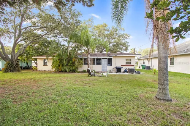 a view of a yard with wooden fence