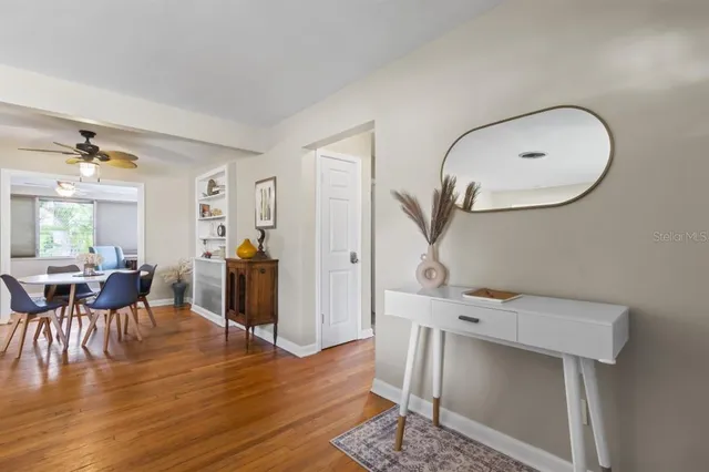 a living room with furniture a window and wooden floor