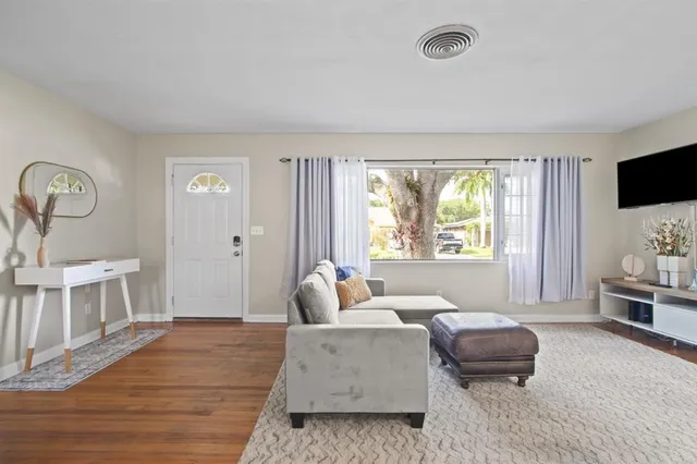 a living room with furniture and a flat screen tv