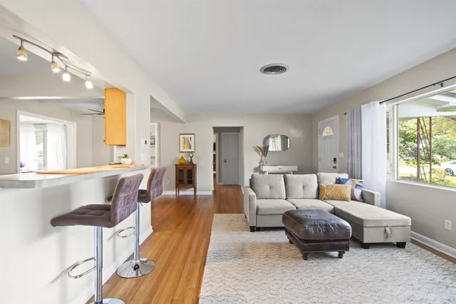 a living room with furniture and a large window