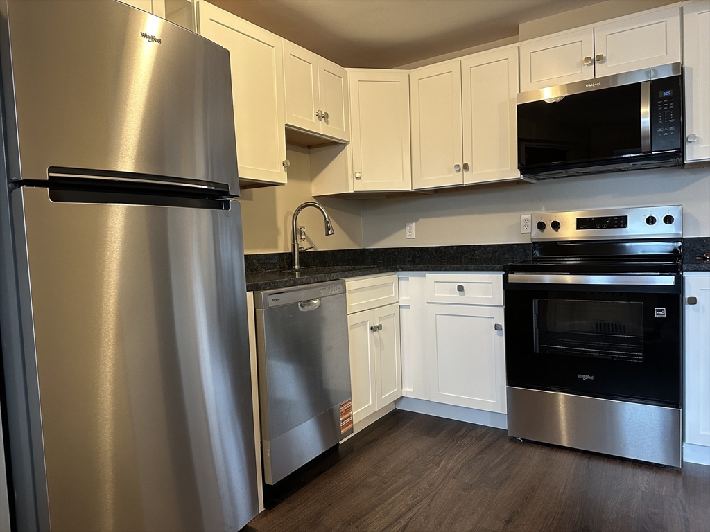 79 Wyman Street, Unit D Newton, MA 02468 - Photo 1 of 12 a kitchen with stainless steel appliances a refrigerator sink and microwave