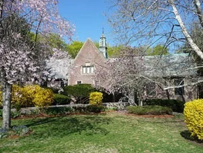 a front view of a house with a garden