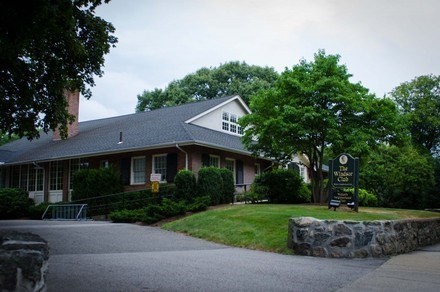 79 Wyman Street, Unit D Newton, MA 02468 - Photo 12 of 12 a front view of a house with a garden