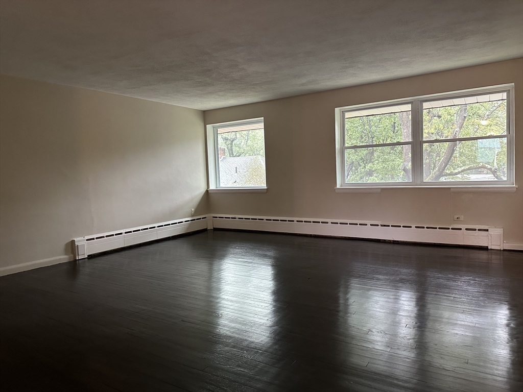 79 Wyman Street, Unit D Newton, MA 02468 - Photo 2 of 12 a view of a room with wooden floor and a window