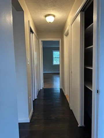 a view of a hallway with wooden floor