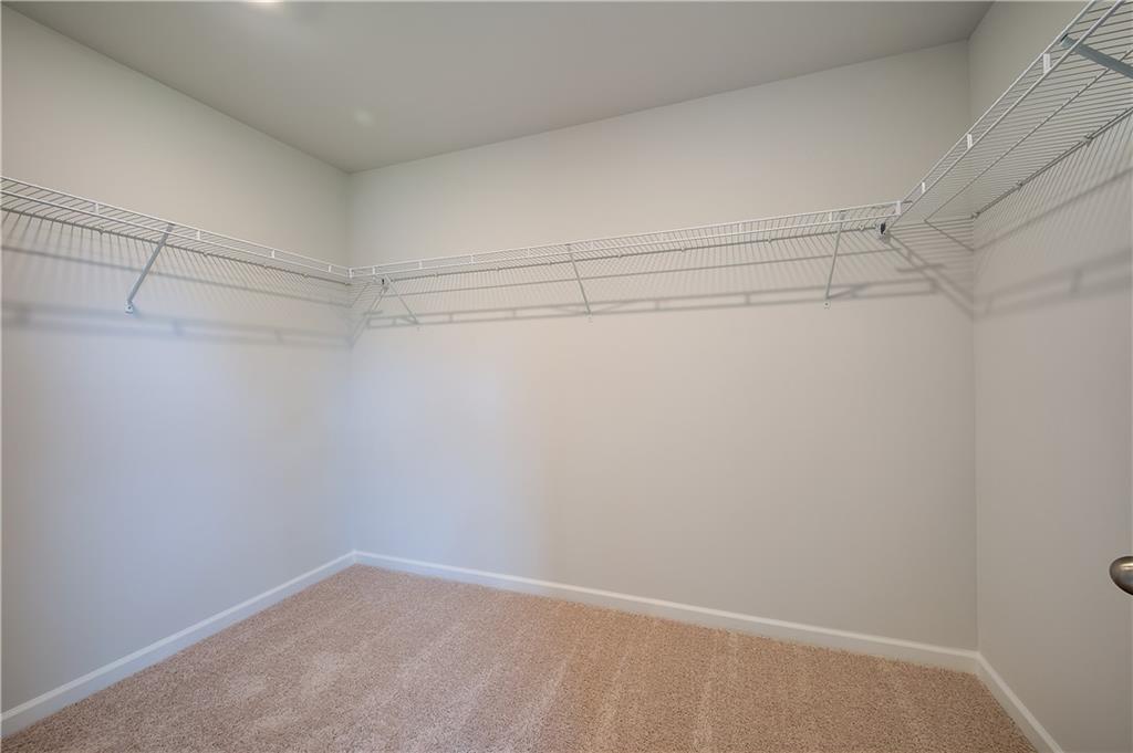 419993 St Anne's Place Covington, GA 30016 - Photo 22 of 30 a view of a room with racks on the wall