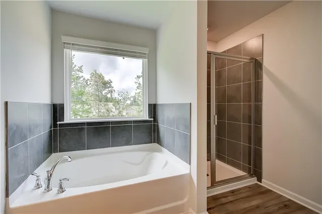a bathroom with a tub and shower